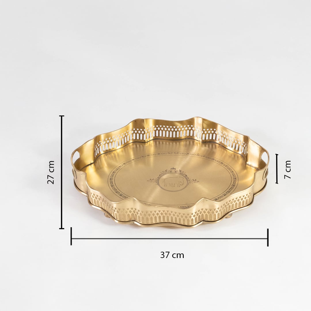 Brass tray with 37 cm width 29 cm depth and 7 cm height shown with cutout border and engraved design on white.