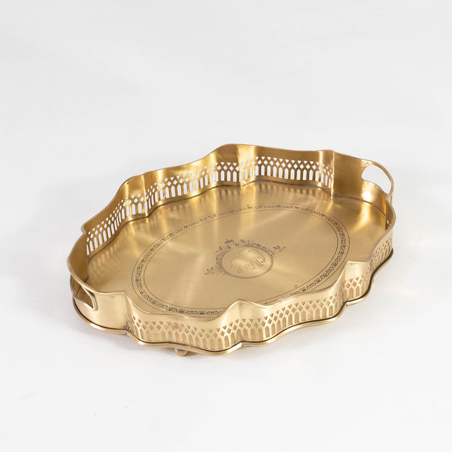 Classic metal serving tray in gold finish with textured edge and engraved pattern for dining table or serving decor placement white background.