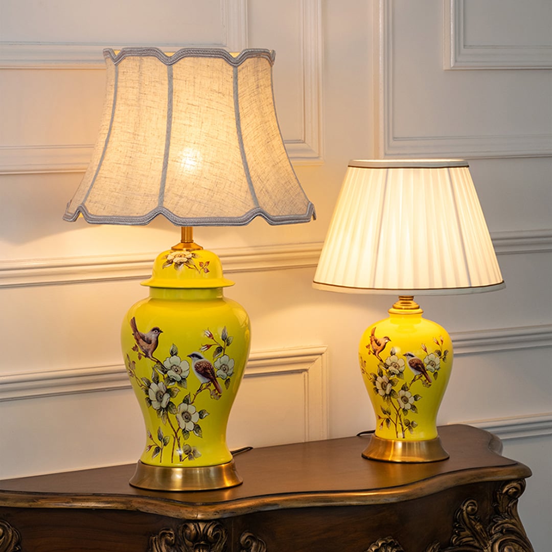 Astra crystal lamps with pleated white shades and gold bases grouped together with light turned on for luxury home lighting.