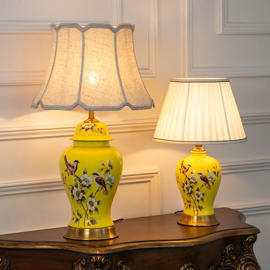 Astra crystal lamps with pleated white shades and gold bases grouped together with light turned on for luxury home lighting.