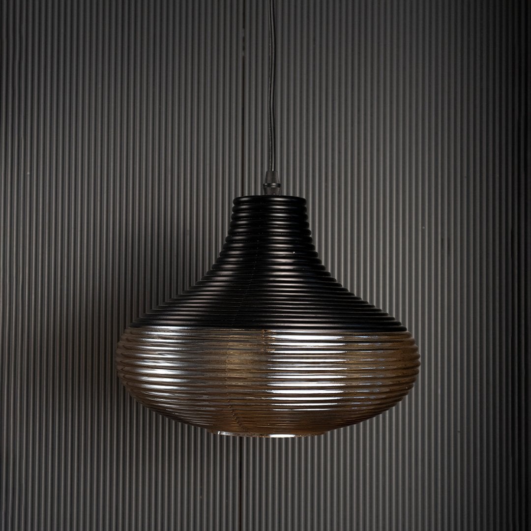 Red glass pendant light with gold cap shown against black background perfect for adding elegance to modern spaces.