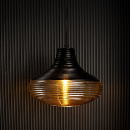Red glass pendant light glowing brightly on black background enhancing warmth and sophistication in interiors.