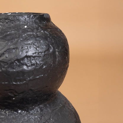 Closeup of black textured decorative vase showing detailed handcrafted surface ideal for adding artistic modern style to home interiors.