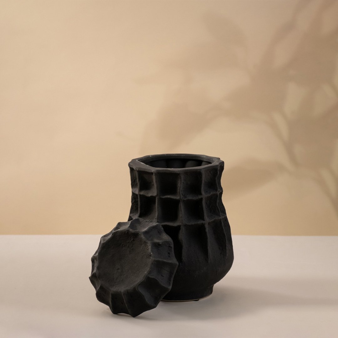 Black ceramic decorative vase with geometric sculptural texture for contemporary shelf styling and modern home decor.