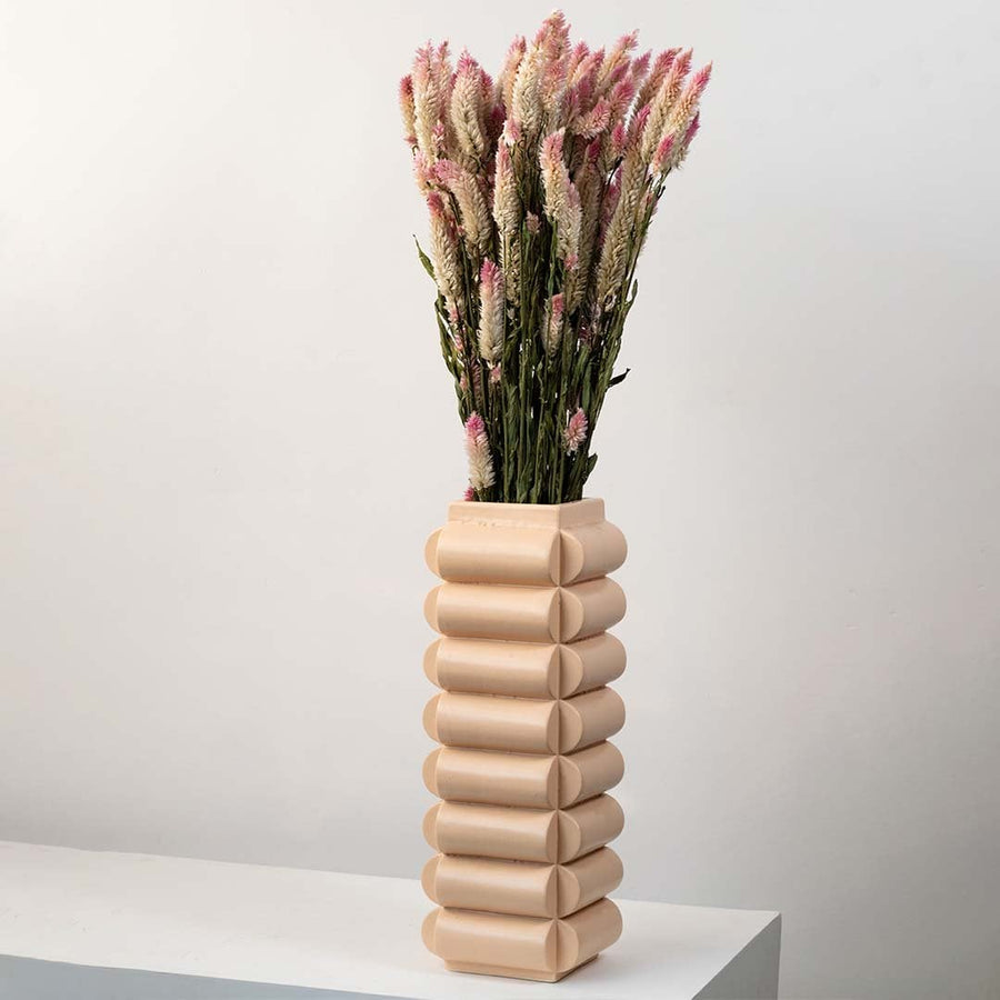 Dried flower styled in a tall ceramic vase creating a warm natural home décor accent with a soft earthy aesthetic perfect for modern interior styling.