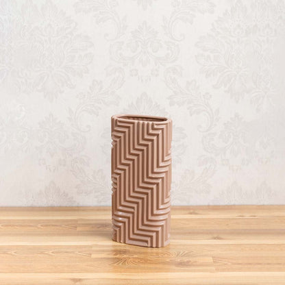 A clean white background view of the beige geometric vase showcasing its sculpted textured design and contemporary decorative appeal.