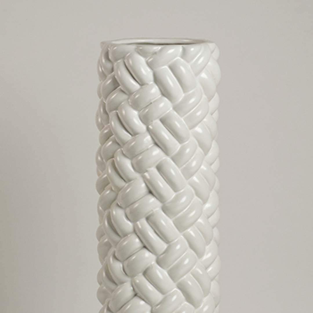 Closeup of tall white ceramic braided floor vase showing detailed woven texture design for modern home interior decoration