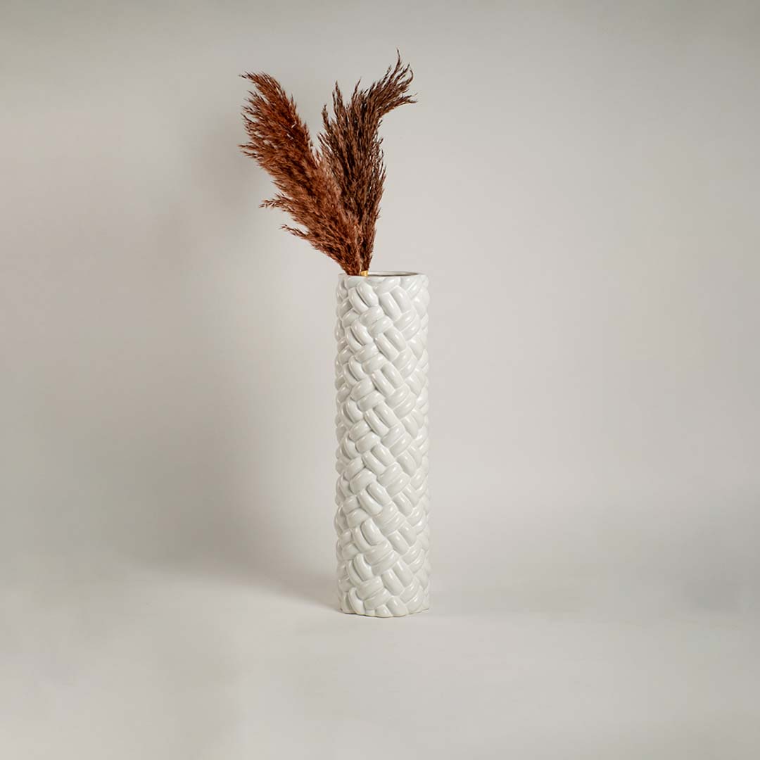 Stylish lifestyle white ceramic tall floor vase with braided pattern perfect for modern home decor and elegant placement.