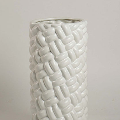 A detailed closeup of the textured white vase showing its woven style surface and smooth finish highlighting craftsmanship and artistic detailing.