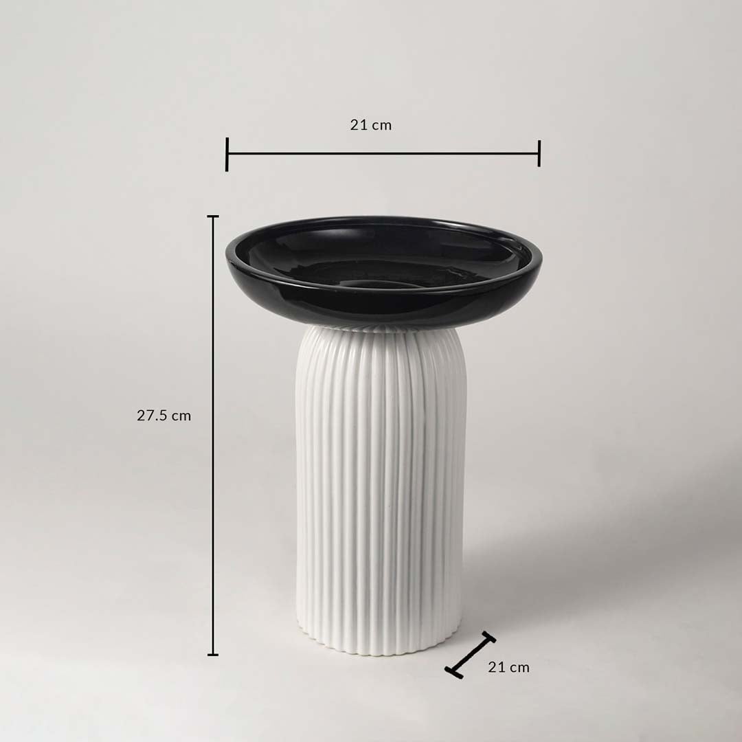 A black and white pedestal bowl shown with measurements of 27.5 cm height and 21 cm width providing clear size details for buyers.