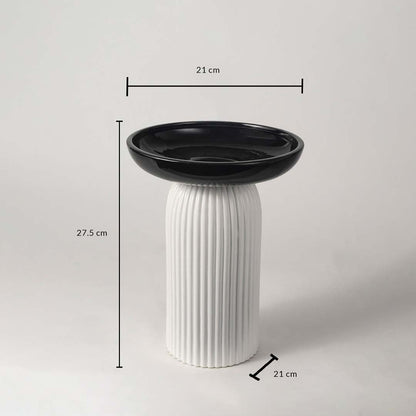 A black and white pedestal bowl shown with measurements of 27.5 cm height and 21 cm width providing clear size details for buyers.