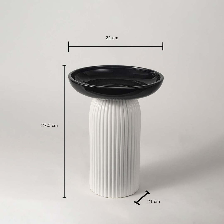 A black and white pedestal bowl shown with measurements of 27.5 cm height and 21 cm width providing clear size details for buyers.