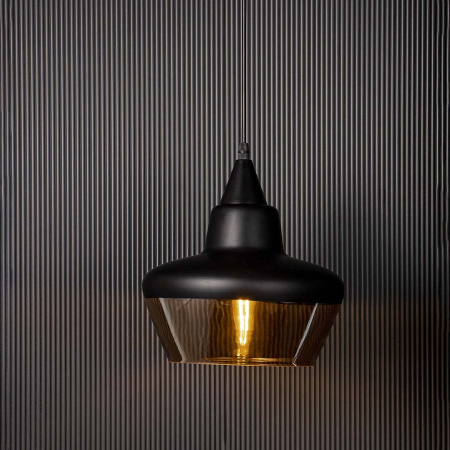Elegant black and amber glass pendant light glowing beautifully against dark background for living room and bedroom use.