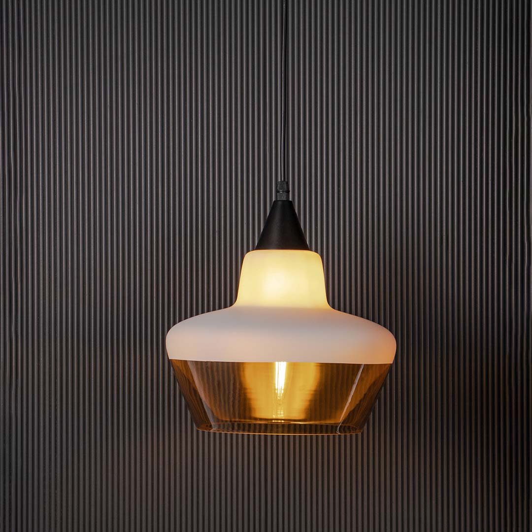 Elegant pendant lamp with white and amber glass shade glowing against dark background ideal for bedroom and living room