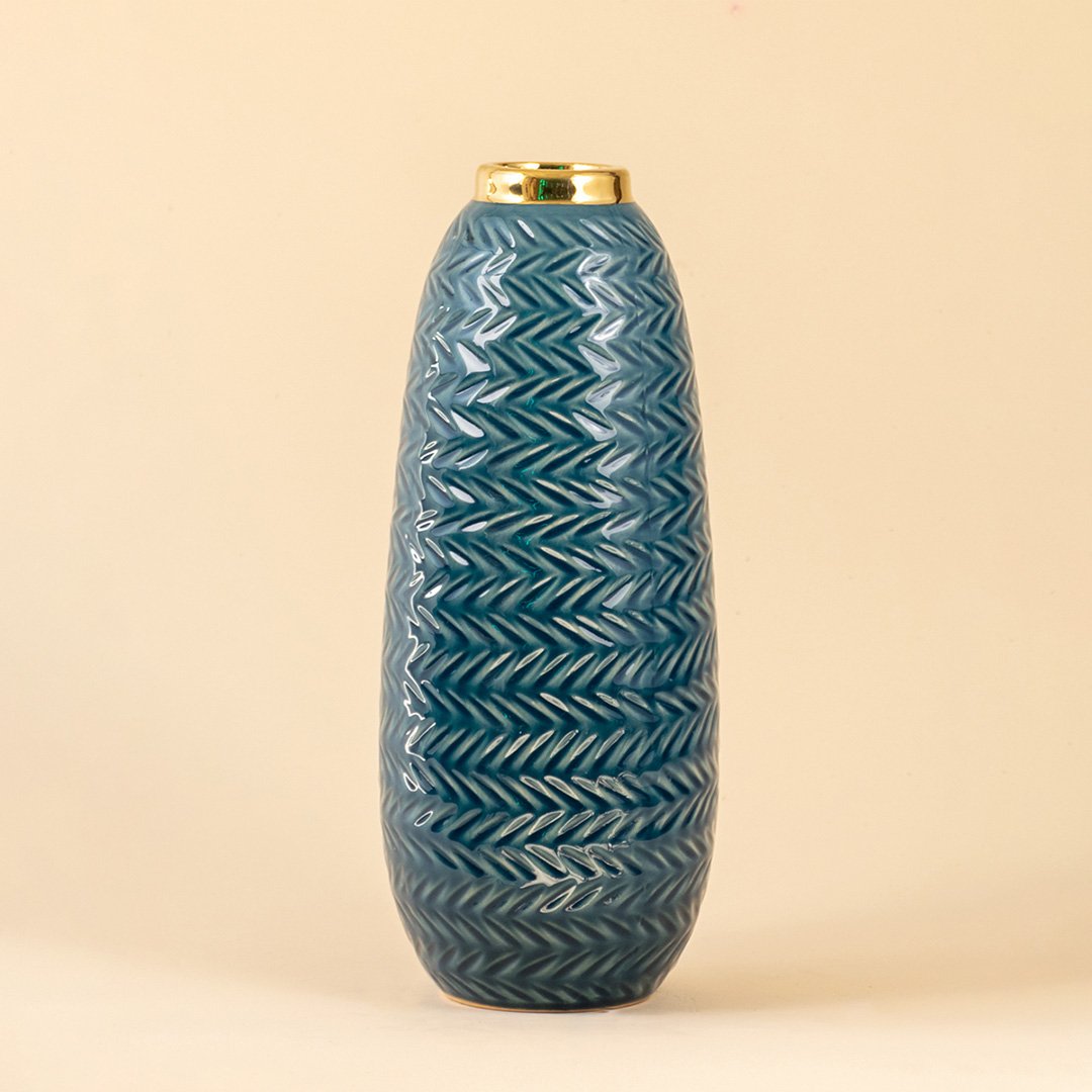 Blue ceramic decorative vase with embossed texture and gold rim for elegant shelf styling and modern home decor.