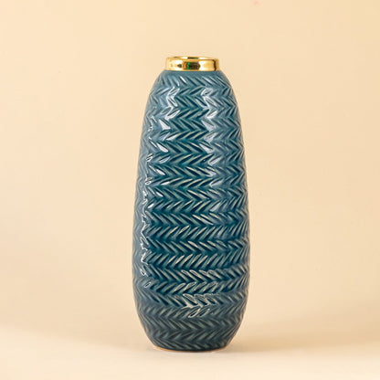 Blue ceramic decorative vase with embossed texture and gold rim for elegant shelf styling and modern home decor.
