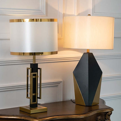 Modern black and gold table lamps with illuminated white drum shades displayed together showcasing stylish lighting options for luxury interiors.