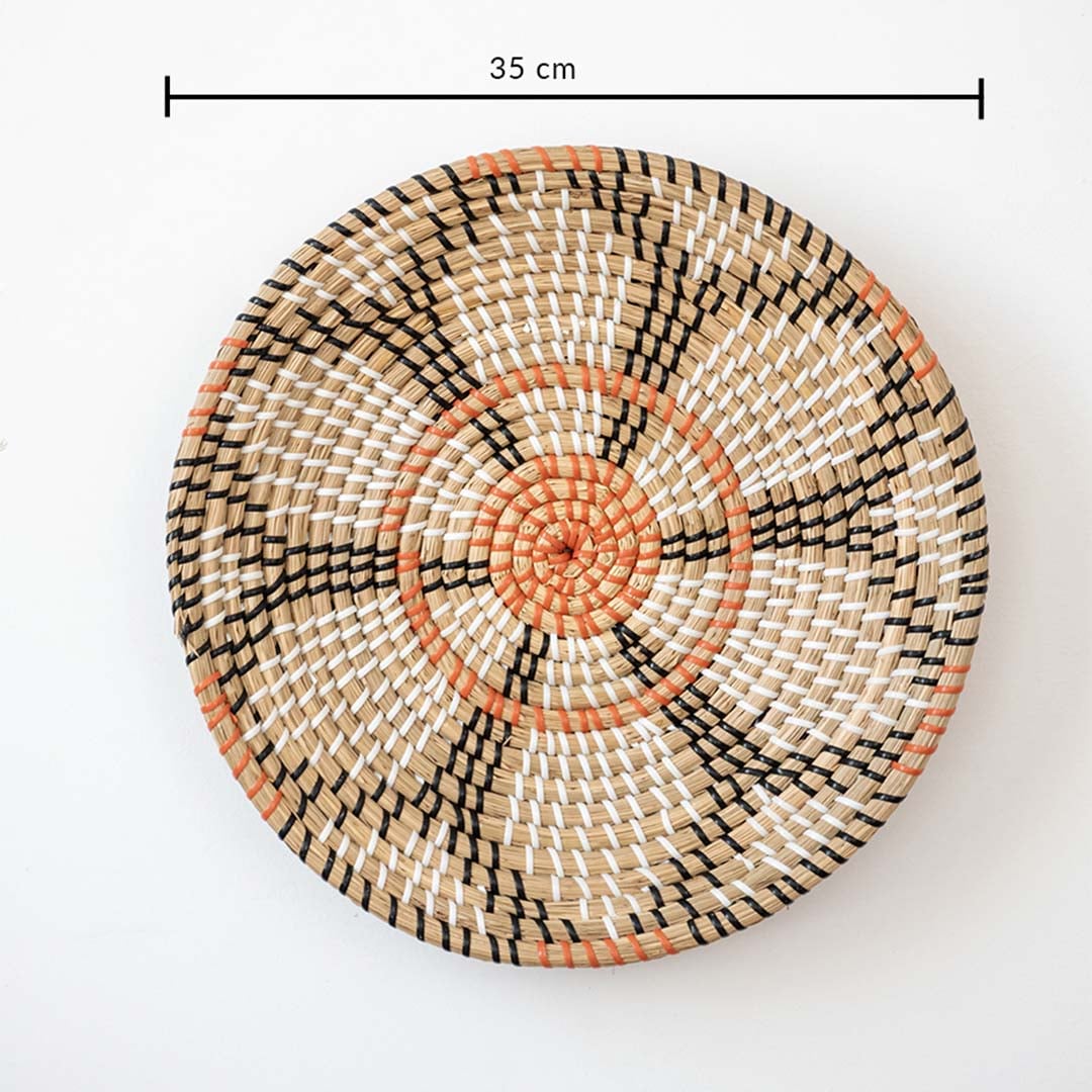 Handwoven wall basket decor in natural orange and black fiber shown with 35cm diameter for decorative wall use.