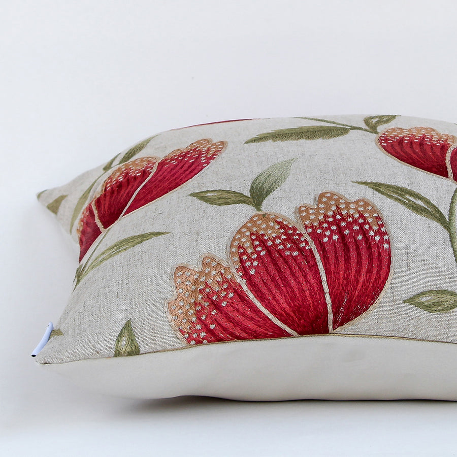 White cotton cushion cover with bold red botanical leaf print highlighting premium cotton fabric and refined stitched detailing.