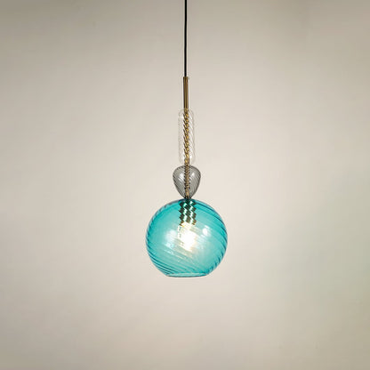 Blue glass pendant light glowing softly on white background showcasing modern design for stylish dining room and living space lighting.