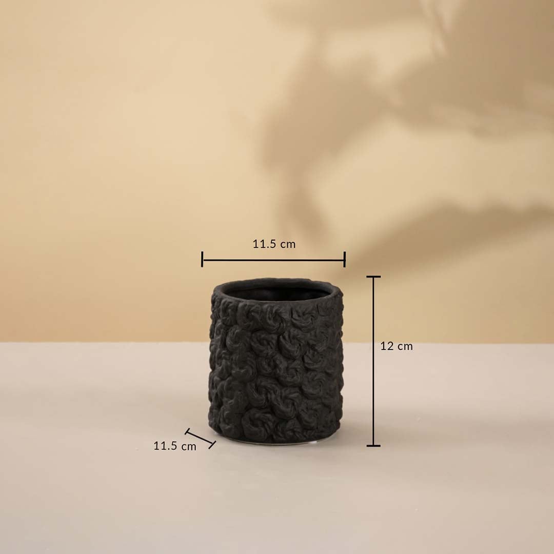 Small round black textured ceramic vase measuring 12 cm in height and 11.5 cm in width displayed on white background.