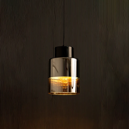 Shiny black metal pendant light illuminated against a dark background highlighting its mirror-like finish and elegant industrial tone.