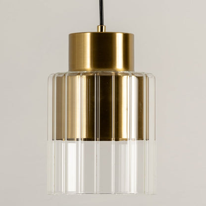 Gold metal pendant light with clear glass shade illuminated to display elegant modern ceiling lighting design.