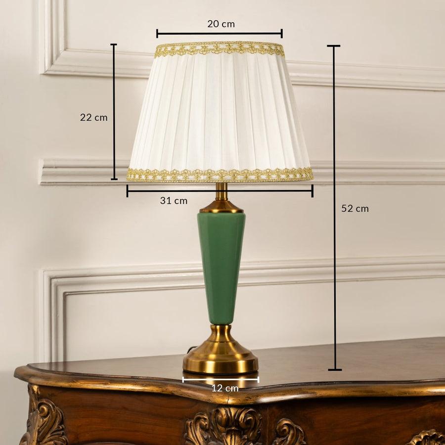 Table lamp with green metal base and white pleated shade shown with 20 cm top width 31 cm bottom width 12 cm base width and 52 cm height for accurate decor placement.