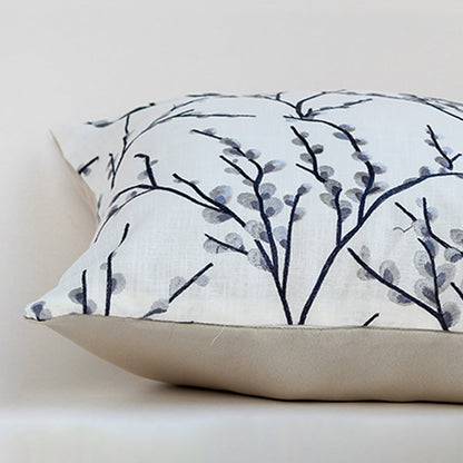 Closeup of the cushion showing the fine stitched grey branches and textured fabric detail.