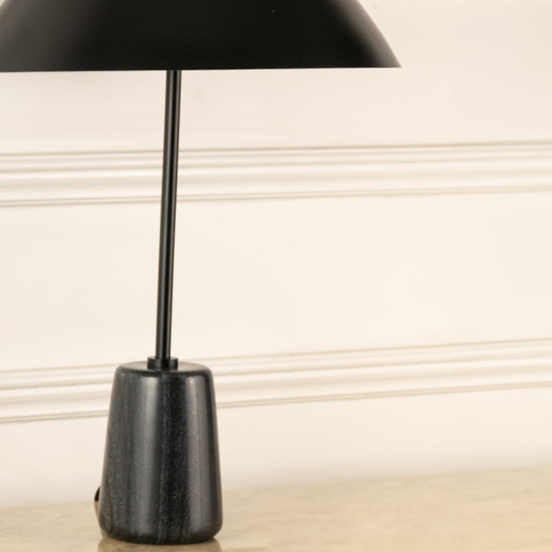 Black marble effect lamp base with slim metal stem showcasing modern craftsmanship and minimalist elegance.