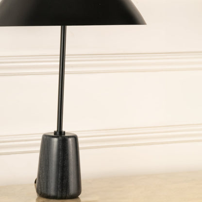 Black marble effect lamp base with slim metal stem showcasing modern craftsmanship and minimalist elegance.