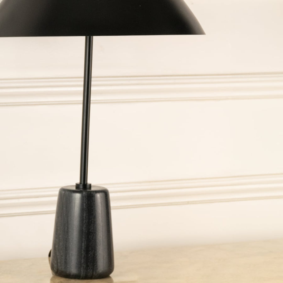 Black marble effect lamp base with slim metal stem showcasing modern craftsmanship and minimalist elegance.