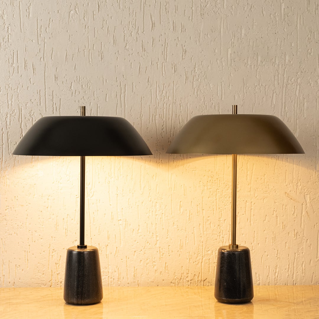 Modern metal table lamps with dome shades emitting warm ambient light for elegant bedroom and living room decor.