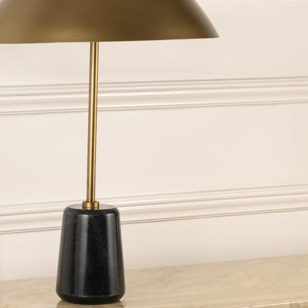 Black marble lamp base with brass stem and metal shade highlighting luxury materials and refined craftsmanship.