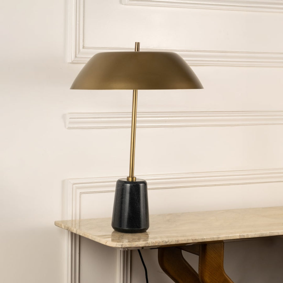Brass table lamp with metal shade and black marble base designed for elegant desk and console table decor.
