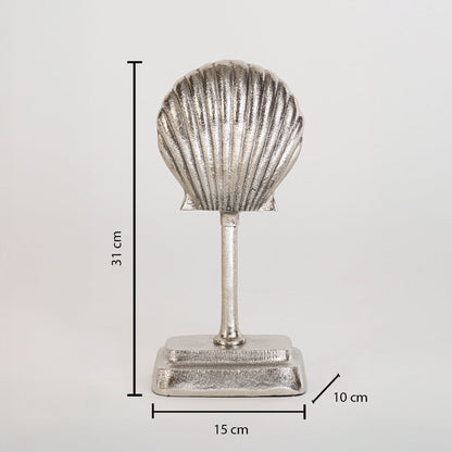 Silver seashell decor piece on base measuring 31 cm high 15 cm wide and 10 cm deep shown against white backdrop