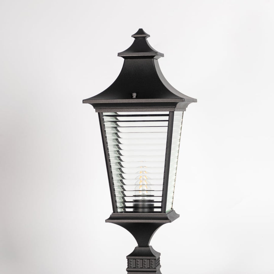 Closeup of black pillar light showing ribbed glass and sleek frame for a premium modern outdoor look.