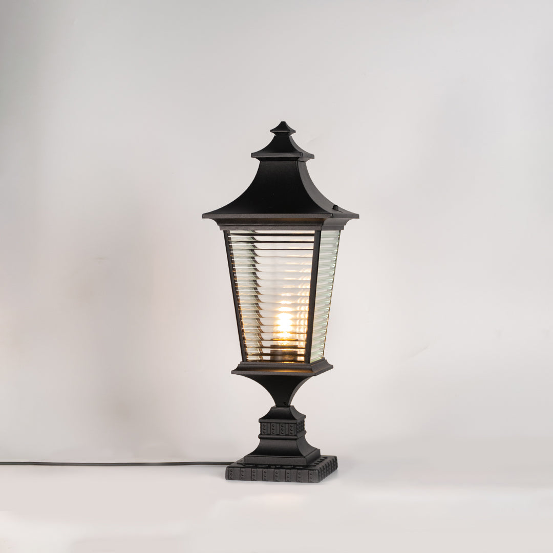 Classic black outdoor gate light with warm glowing bulb for stylish exterior decor styling use.