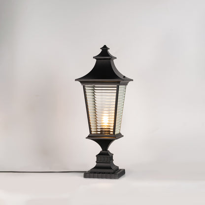 Classic black outdoor gate light with warm glowing bulb for stylish exterior decor styling use.