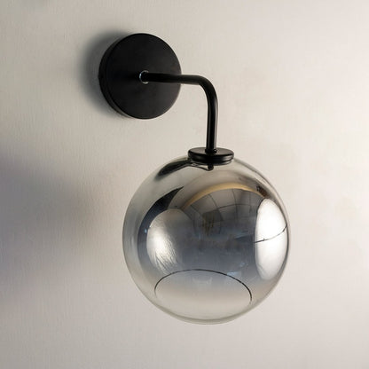 Smoky glass globe wall light with black metal arm displayed on white background ideal for modern home interiors.