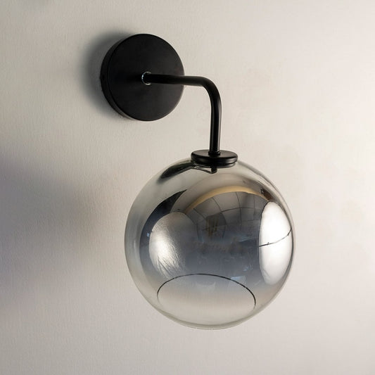 Smoky glass globe wall light with black metal arm displayed on white background ideal for modern home interiors.