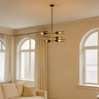 Designer chandelier with black glass blades and gold detailing enhancing dining and living room interiors with soft elegant lighting.