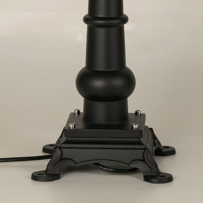 A focused closeup of the lantern top showing the finial structure smooth metal roof and detailed patterned frame that surrounds the frosted glass panel beautifully.
