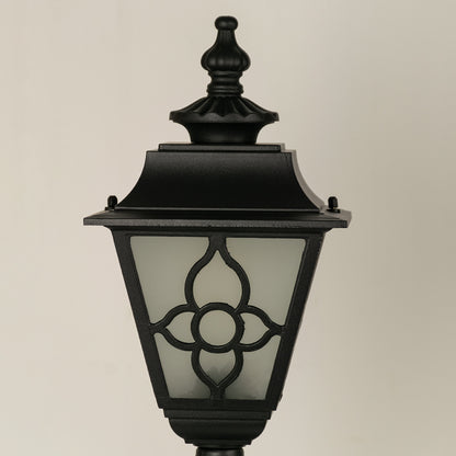 Closeup of black outdoor wall light with floral metal detailing for elegant exterior decor styling.