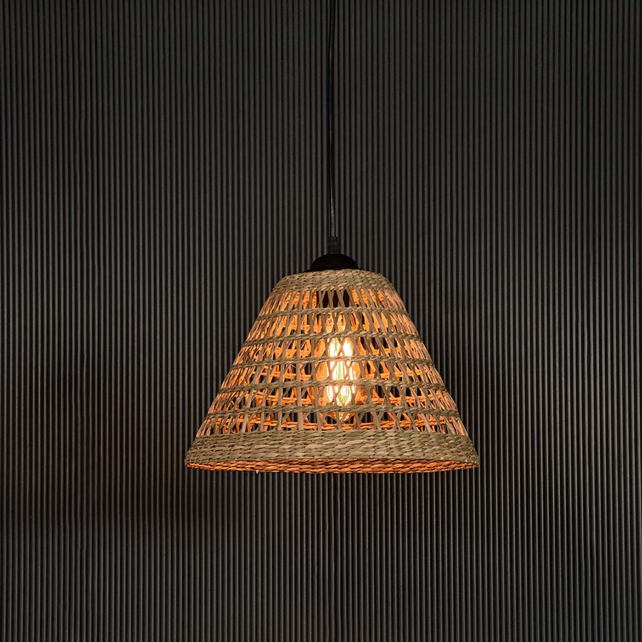 Rattan pendant light with conical woven shade displayed on black background for modern rustic home lighting decor.