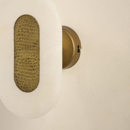 Closeup of white marble and gold metal wall light for elegant hallway and luxury decor styling spaces.