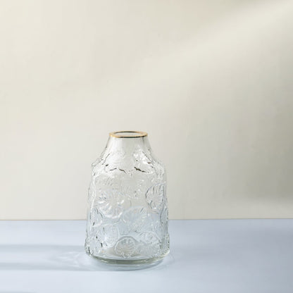 Transparent embossed glass vase with leaf pattern for modern home styling White background Image.