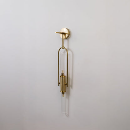 Gold metal wall light with ribbed glass tube shown switched off on white background for minimal stylish home decor.