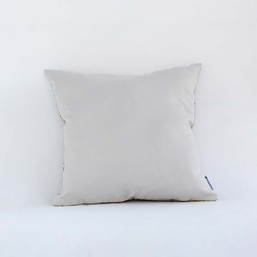 Side view of the floral cushion displaying its plump filled shape and elegant embroidered pattern.