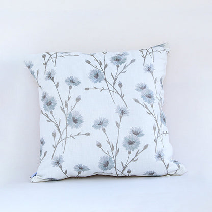 White cotton cushion cover with blue floral botanical print for sofa bedroom seating and timeless home decor styling.